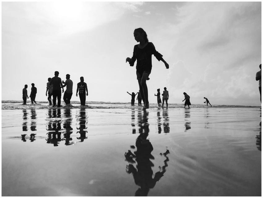 Silhouetted people enjoying a beach day in Goa, In