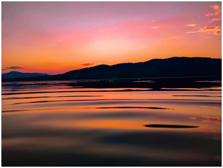 Beautiful sunset over a tranquil lake with vibrant