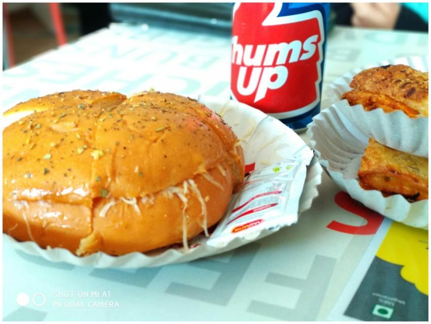 A close-up of a burger and soda, perfect for fast
