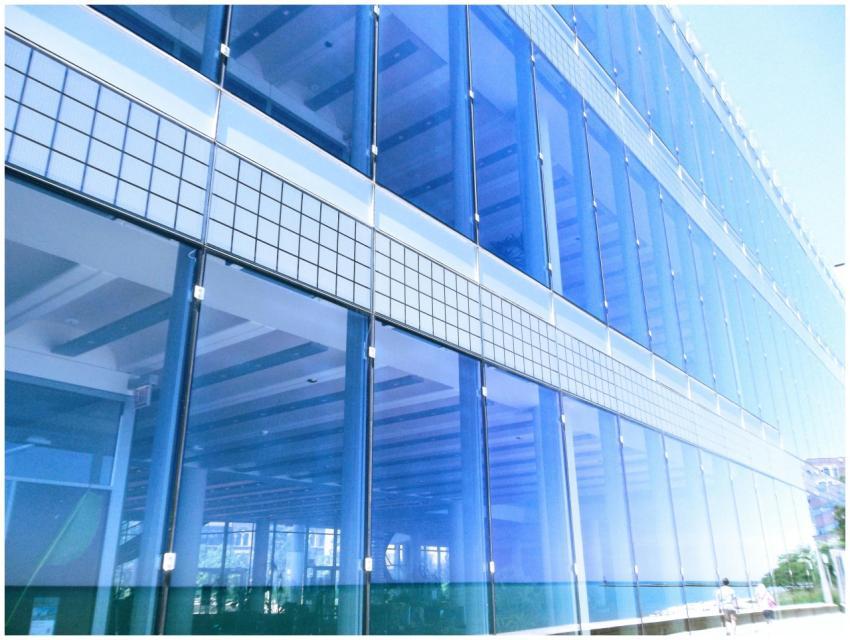 Contemporary glass building facade with reflection