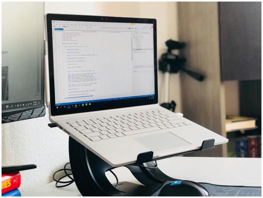 A home office setup featuring a laptop on a stand