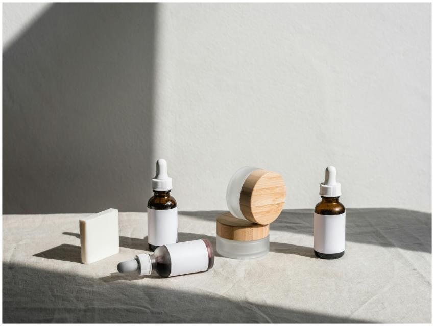 Flat lay of skincare products in jars and dropper