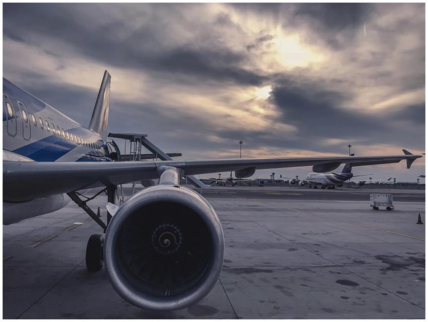 A passenger airplane is parked on the tarmac at su