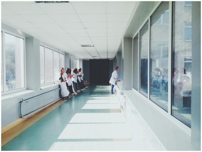 A brightly lit hospital hallway with medical staff