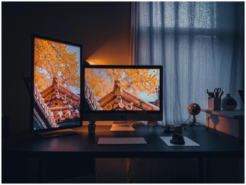 Cozy home office setup with dual monitors displayi