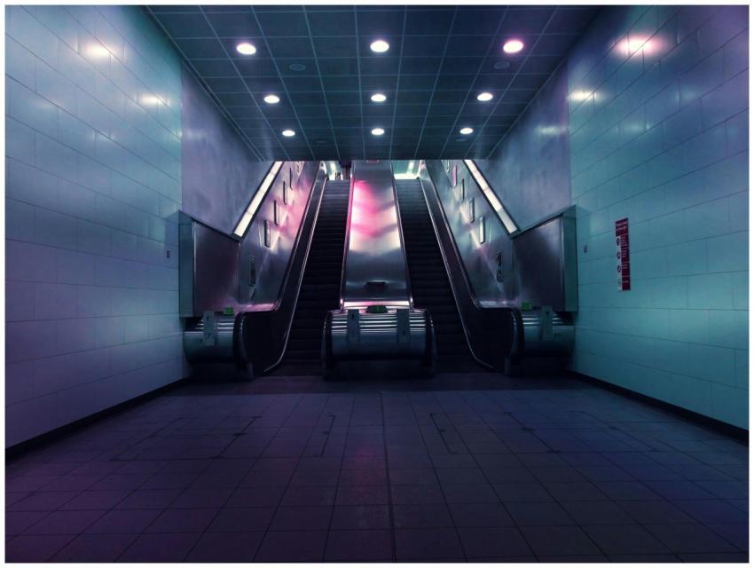 A futuristic escalator scene in an empty undergrou