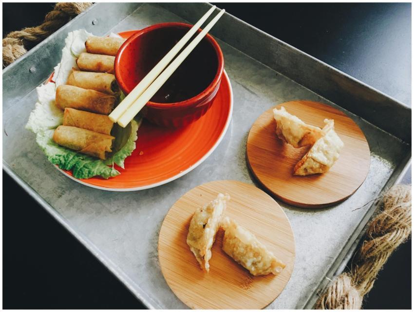 Appetizing Asian dumplings on bamboo plates with c