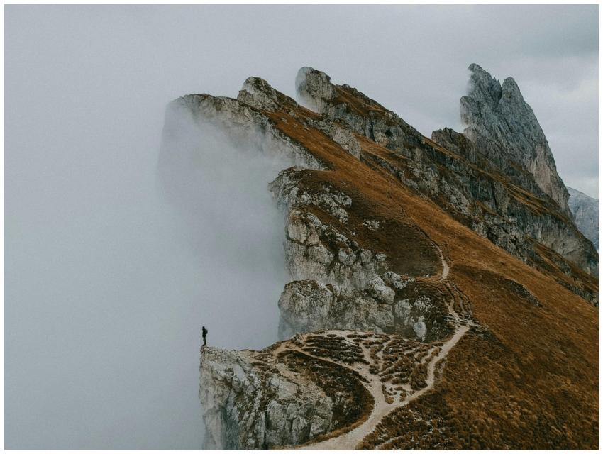 A solitary figure on the misty cliffs of the Dolom