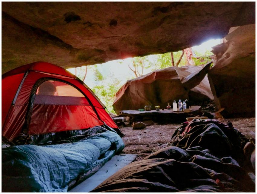 Explore the serenity of cave camping with a red te
