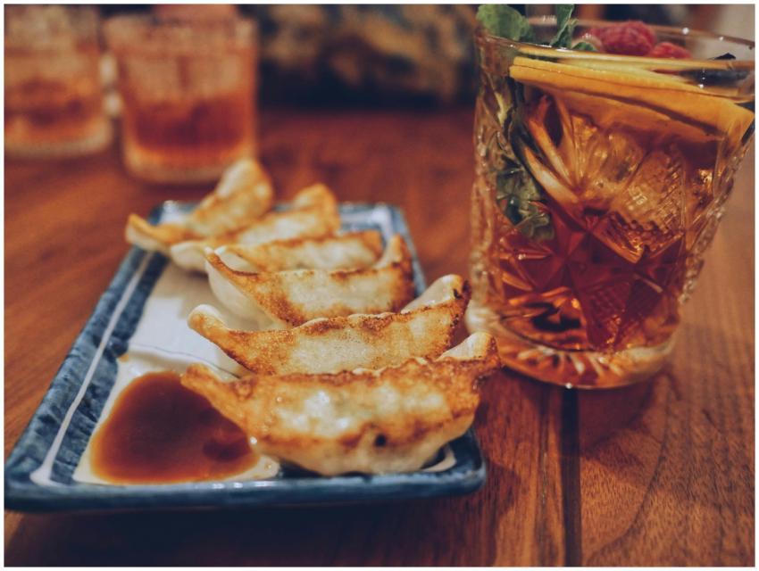 Close-up of fried dumplings with dipping sauce and