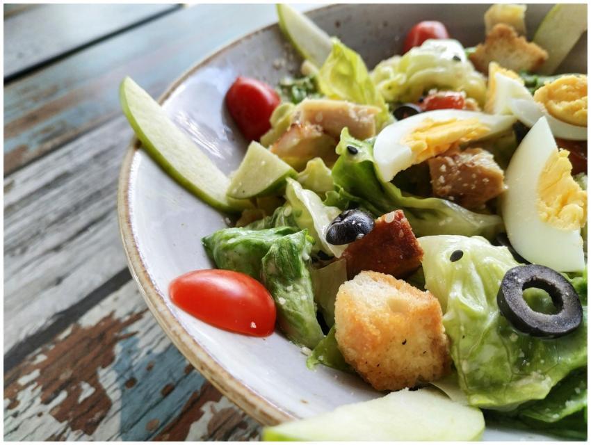 A close-up of a Caesar salad featuring fresh lettu
