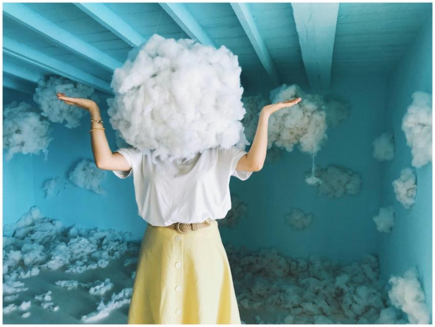 Whimsical art piece with a person having a cloud a