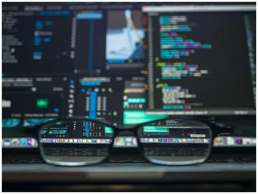 Eyeglasses reflecting computer code on a monitor,