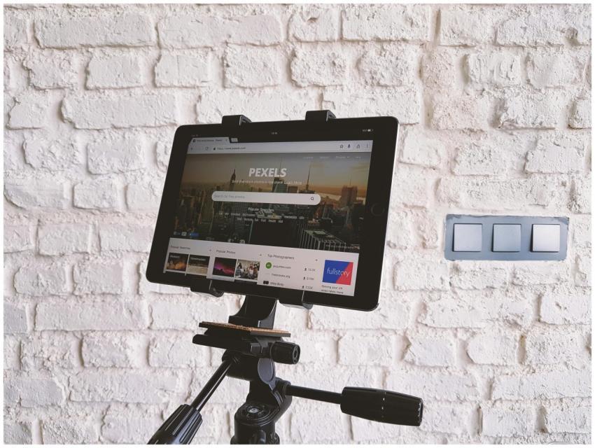 Tablet mounted on a tripod, displaying a website,