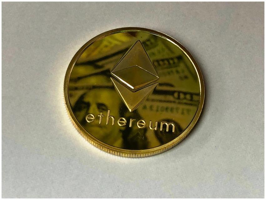 Close-up of a shining Ethereum coin reflecting a d