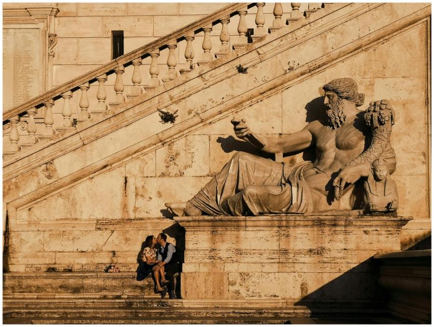 A couple shares a romantic moment by a historic st