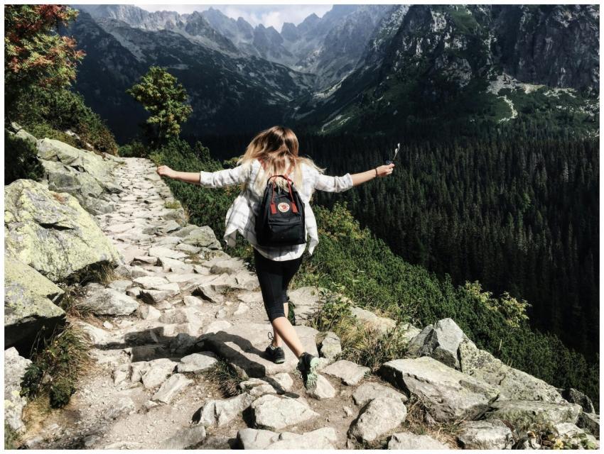 Woman hikes along rocky path in Vysoké Tatry, Slov