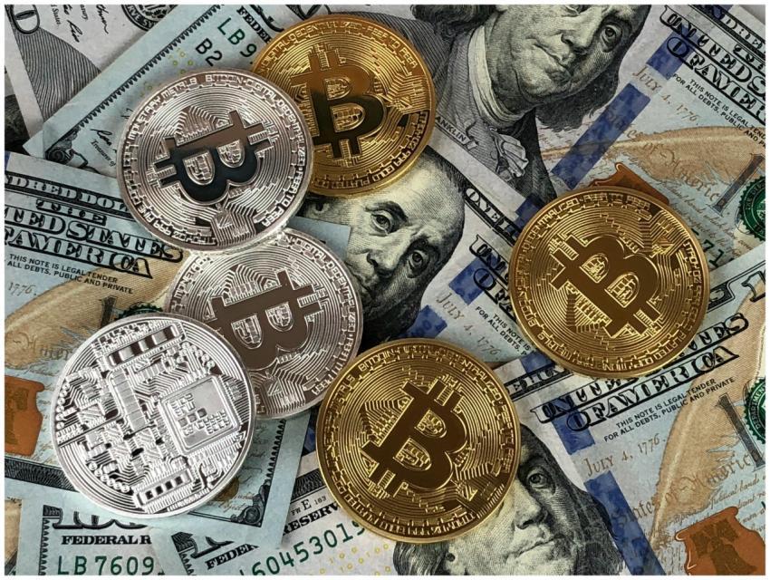 Close-up of bitcoins and US dollar bills symbolizi