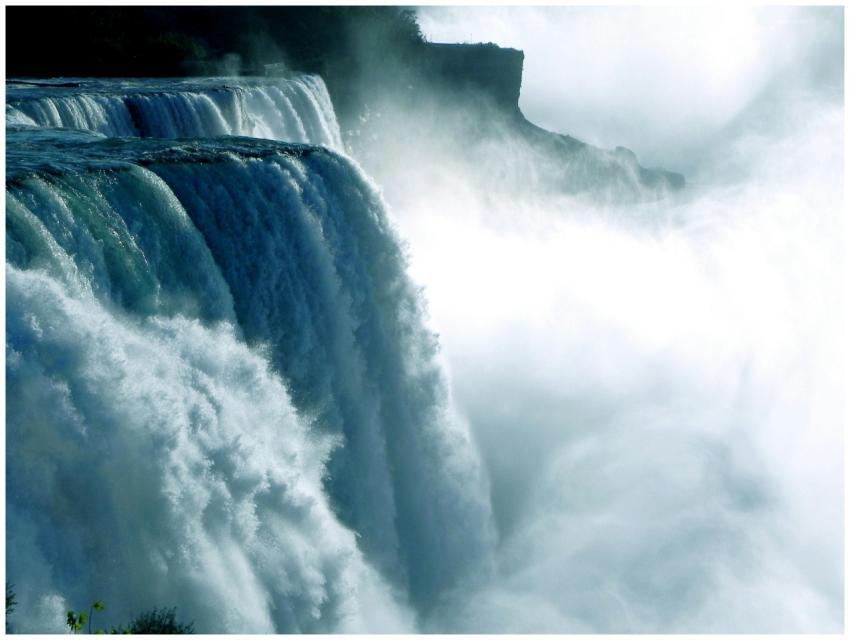 Dramatic waterfall cascading amid mist, capturing