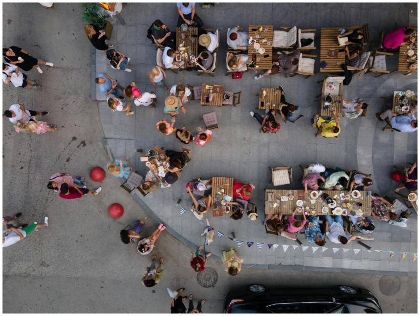 Top-down drone shot of people dining outdoors at a