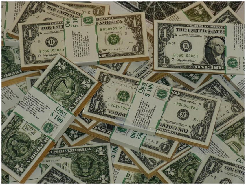 Numerous bundles of US one dollar bills symbolizin