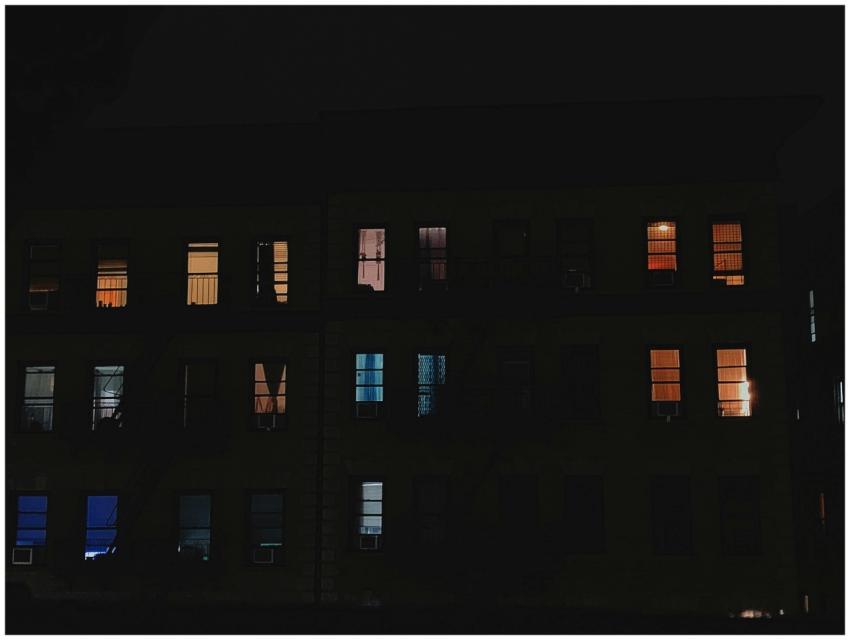 A vibrant night view of colorful apartment windows