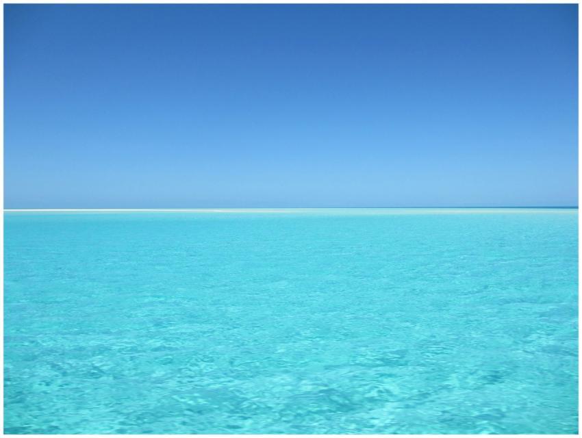 A serene blue ocean with crystal clear water under