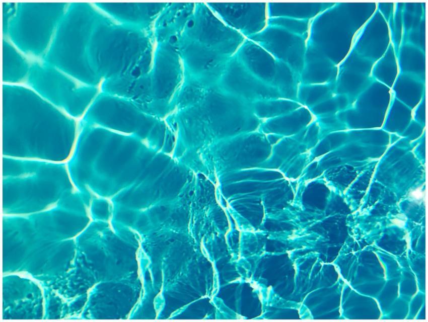 Bright turquoise water surface in sunlight, captur