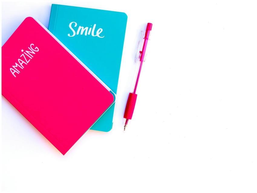 Colorful flat lay with turquoise and pink notebook