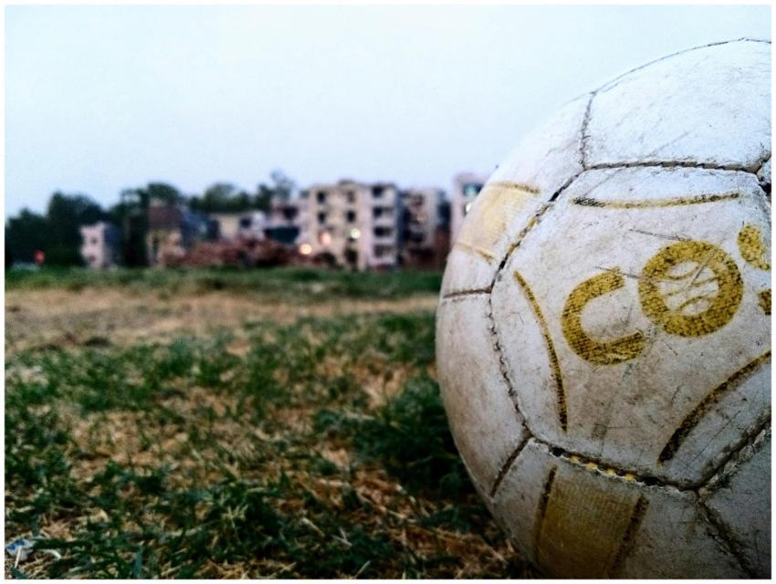 A detailed view of a soccer ball on a grassy field