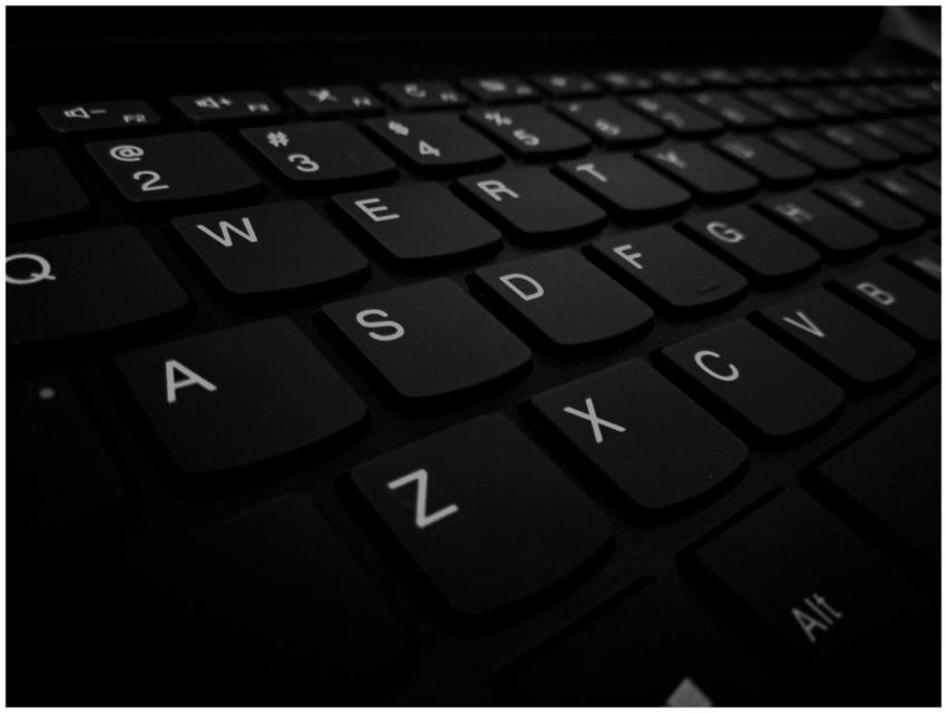 Dramatic close-up of a black computer keyboard sho