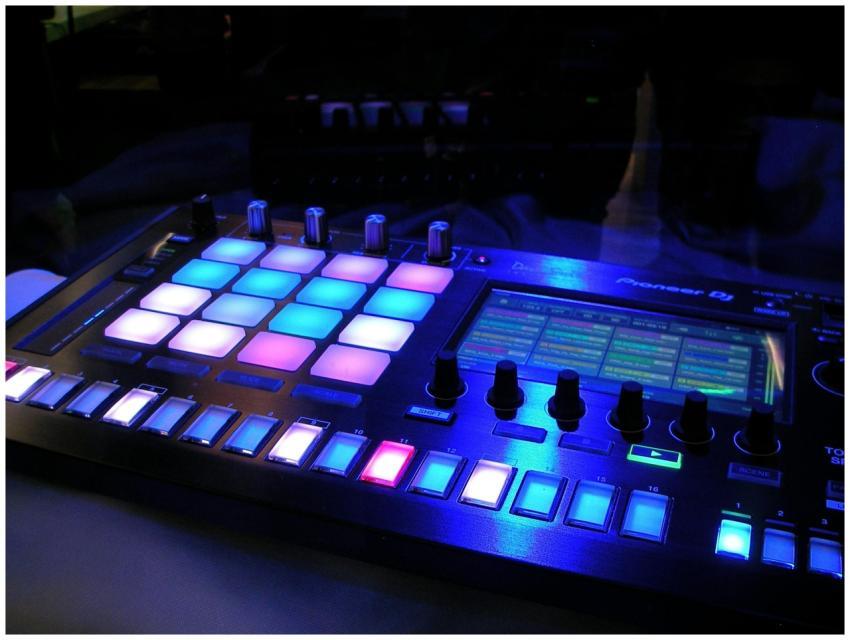 Close-up of an illuminated DJ mixer with vibrant L