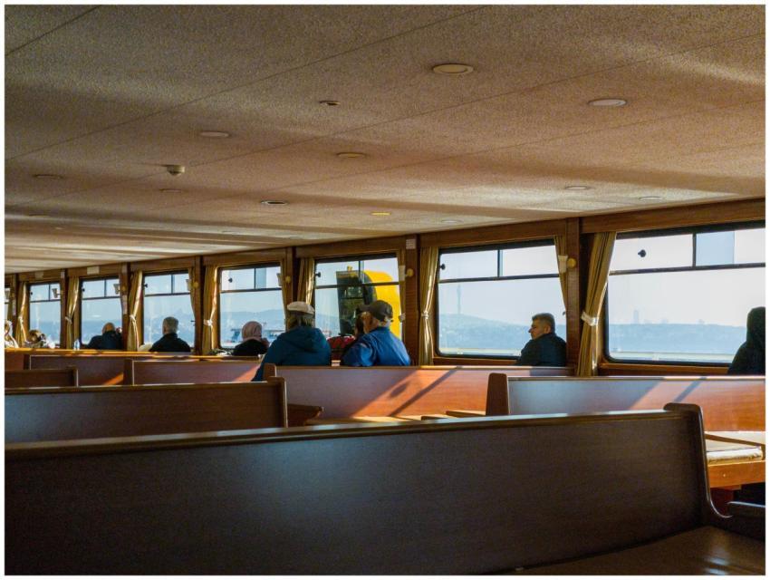 A group of passengers enjoys a peaceful ferry ride
