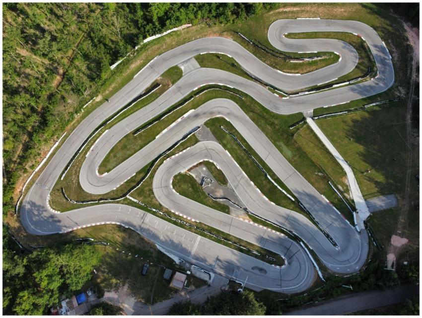 Drone shot of a winding racetrack surrounded by lu