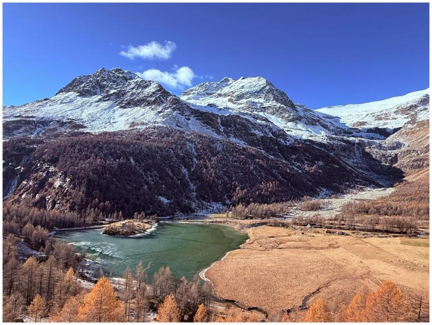 Beautiful view of a mountain lake surrounded by sn