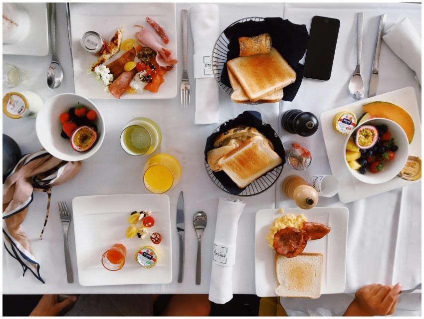 Flatlay of an elegant brunch setup with fruits, to