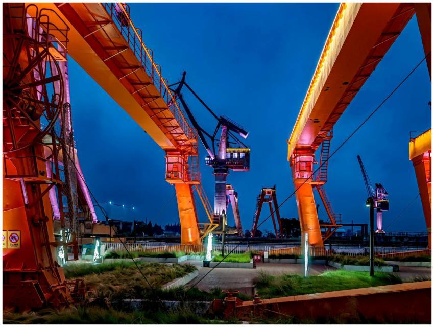 Vibrant industrial cranes glowing at night in Shan