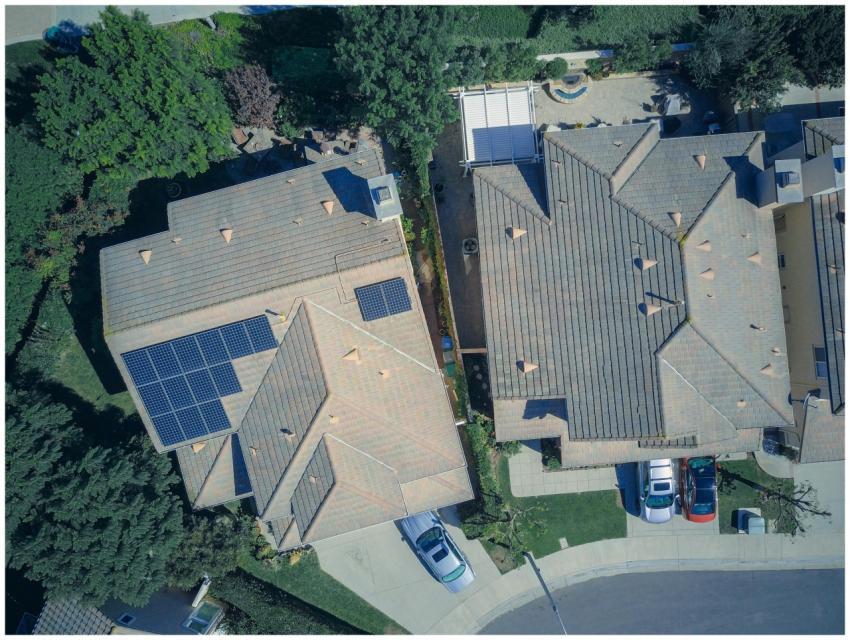 Top view of houses with solar panels, showcasing c