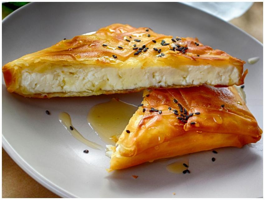 A delicious Greek cheese pie drizzled with honey,