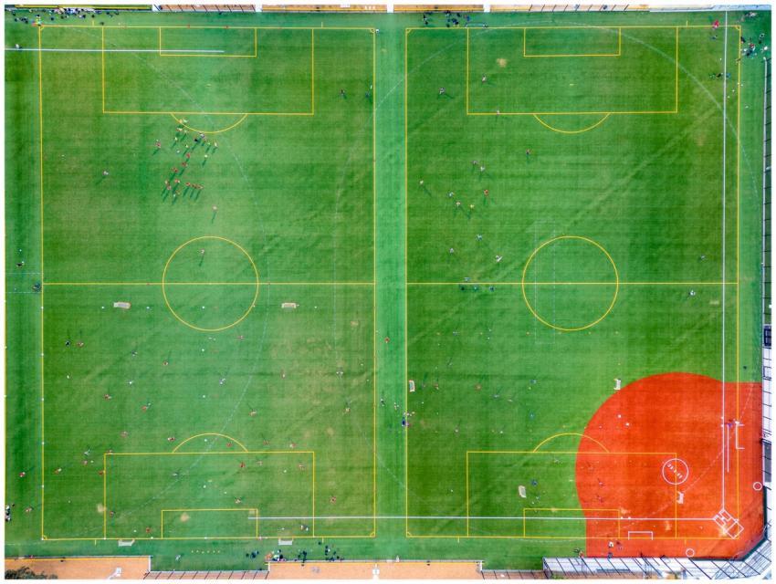 Aerial shot of a vibrant green soccer field with p