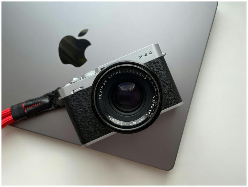 Modern mirrorless camera resting on a sleek laptop