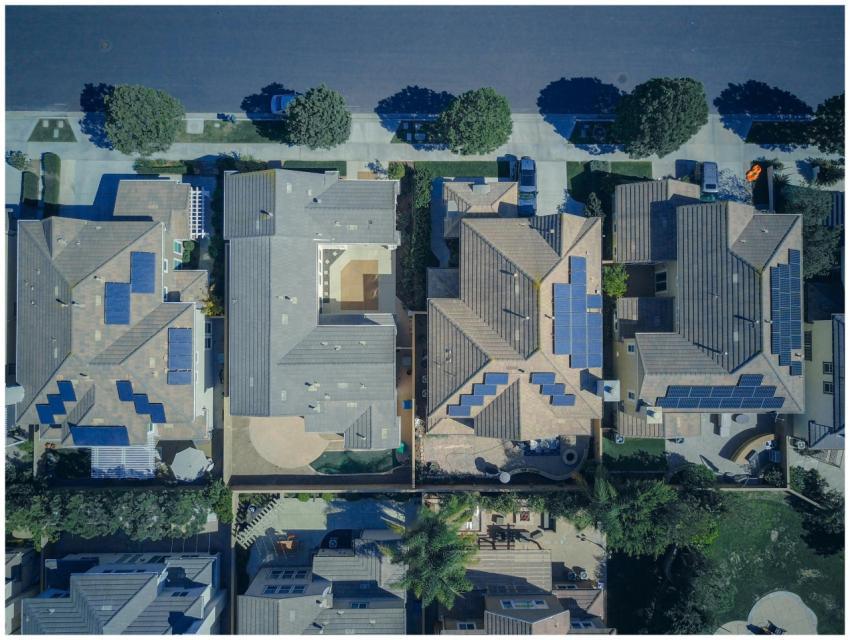 Top-down view of urban houses with solar panels em