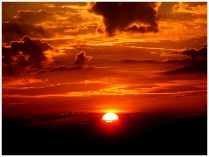 Vivid sunset with a glowing sun on the horizon and