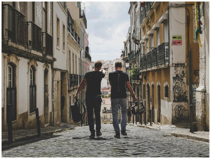 Two friends walking through Lisbon's charming cobb