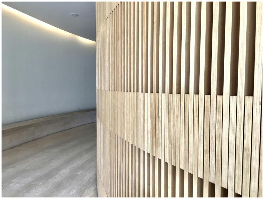 Contemporary hallway with wooden slat wall emphasi