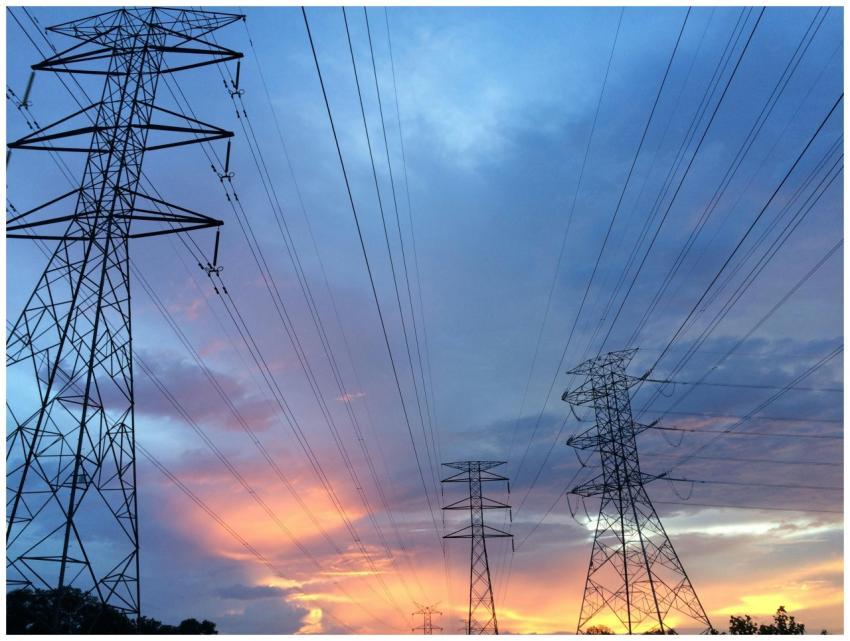 A scenic view of high voltage power lines silhouet