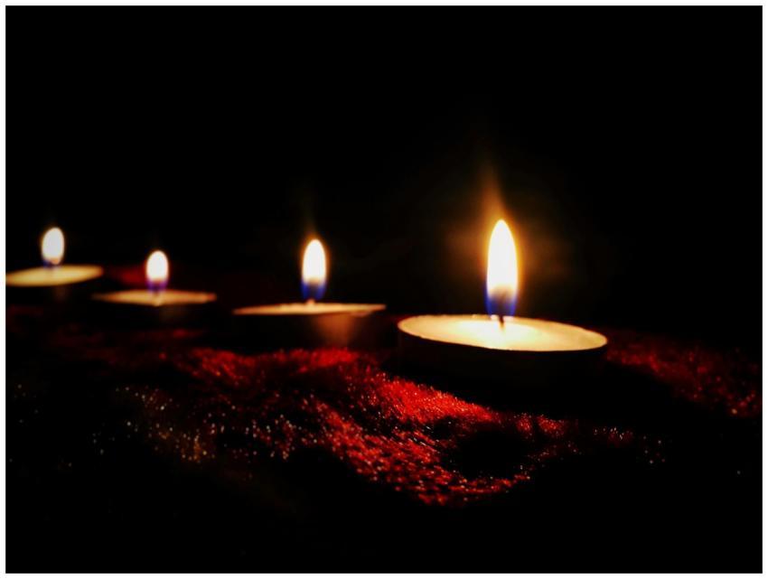 Row of candles casting a warm, soothing light in t