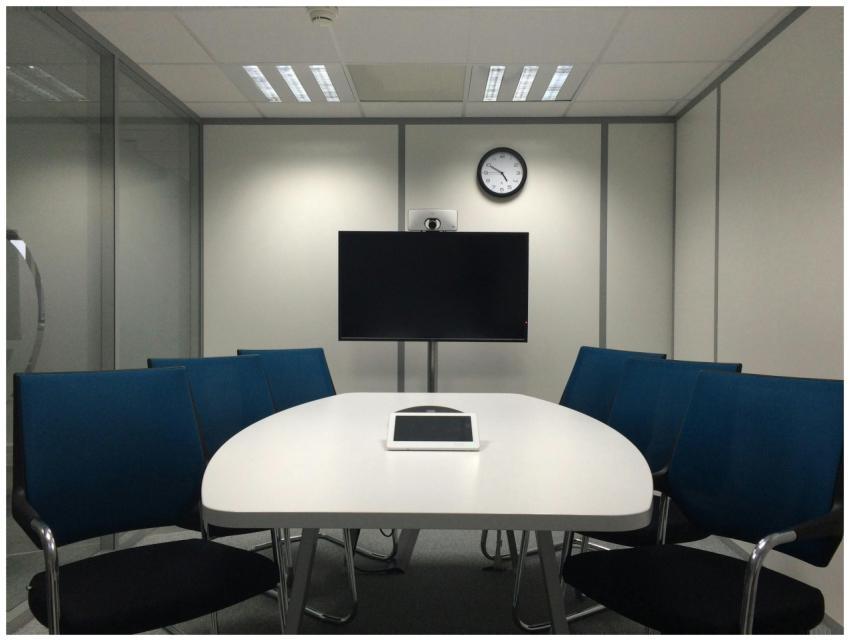 Sleek conference room with a table, chairs, TV, an