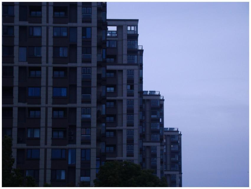 A contemporary skyscraper in a cityscape at dusk s