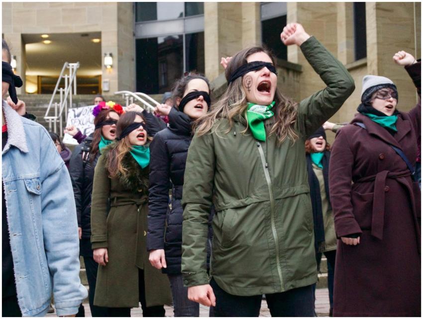 A dynamic group of women protesting for feminism a